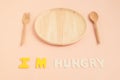 I'm hungry text with wooden plate and cutlery