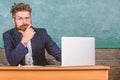 I am your new teacher. Teacher bearded hipster with eyeglasses sit in classroom chalkboard background. School teacher