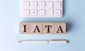 IATA on wooden cubes with pen and calculator, financial concept Royalty Free Stock Photo