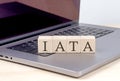 IATA word on wooden block on laptop, business concept Royalty Free Stock Photo