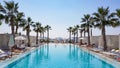 Swimming pool in a hotel resort, palm trees, tropical vibe.