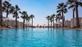 Swimming pool in a hotel resort, palm trees, tropical vibe.