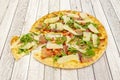 Iberian pizza with arugula, ham from the cellar, slices of manchego cheese, tomato tacos Royalty Free Stock Photo