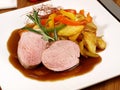 Fine Meat - Iberian Pork Fillet with roasted Potatoes and red Pepper isolated on white Plate Royalty Free Stock Photo