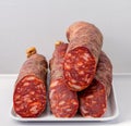 Iberian sausage cut in half on white background Royalty Free Stock Photo