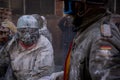 A man dressed as a soldier with a mask in the middle of a battle with flour and eggs at a traditional winter festival