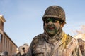 Portrait of a man covered in flour and eggs dressed as a soldier in the middle of a fun battle at a traditional winter festival