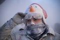 Traditional winter festival and masquerade \'Els Enfarinats\'. Portrait of a man in the middle of flour battle