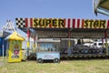 Ibitinga, SP, Brazil - 02 07 2021: A vintage popcorn cart in front of a Bumper Cars Ride at an Amusement Park