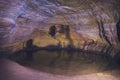 Ibitipoca national park in Brazil cave with little lighting and a small lake Royalty Free Stock Photo