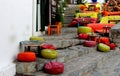 Pouffes and colorful cushions over a perron in a picturesque street Royalty Free Stock Photo