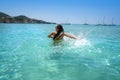 Ibiza bikini girl splashing clear water beach