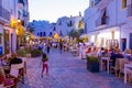 View on crowded street with cafe, bars and restaurants in old town Dalt Vila,in summer in evening illumination, Ibiza, Spain Royalty Free Stock Photo