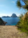 Ibiza and its wonders. the crystal blue sea, the islet of Es Vedra seen from the cliffs of Cala D`Hort in a blue summer tourist