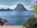 Ibiza and its wonders. the crystal blue sea, the islet of Es Vedra seen from the cliffs of Cala D`Hort in a blue summer tourist