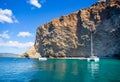 Idyllic turquoise water cove in Ibiza island with rock formation. Catamaran and yacht anchored for Royalty Free Stock Photo