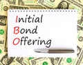 IBO initial bond offering symbol. Concept words IBO initial bond offering on beautiful white note. Beautiful dollar bills