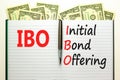 IBO initial bond offering symbol. Concept words IBO initial bond offering on beautiful white note. Beautiful dollar bills