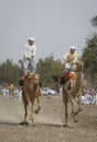 Omani man riding a camel on a coutryside of Oman Royalty Free Stock Photo