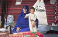 Bedouin woman with her kid in a tent