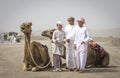 Young men with their camels bifore a race