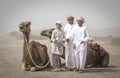 Young men with their camels bifore a race