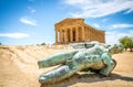 Icarus bronze statue and Temple of Concordia in the Valley of Temples in Agrigento, Sicily, Italy