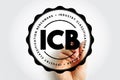 ICB Industry Classification Benchmark displayed as a circular stamp held by a hand, with bold initials in the center and Royalty Free Stock Photo