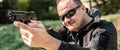 Police agent and bodyguard pointing pistol to protect from attacker Royalty Free Stock Photo