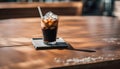 ice americano coffee with black straw on concrete coaster and wooden table