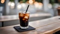 ice americano coffee with black straw on concrete coaster and wooden table