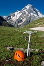 Ice-axe and helmet on the mountain background. Royalty Free Stock Photo