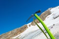 Ice axe positioned in snow with mountaineers walking in the background. Royalty Free Stock Photo