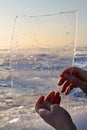 Woman hands holding ice . Lake Balaton in Winter, Hungary. Royalty Free Stock Photo