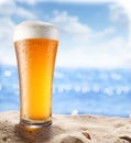 Ice beer glass in the sand. Royalty Free Stock Photo