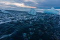 Ice blocks on the black sand beach during sunset in Iceland