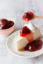 Ice box cheese cake with strawberry jam and whipping cream on white background Royalty Free Stock Photo