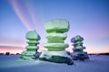 ice-carved inukshuks framed against radiating aurora