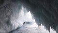 Ice cave grotto in winter. Ice icicles at the entrance to the cave at Olkhon island in Siberia in Russia. Travel in frosty weather