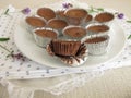 Ice chocolate with cocoa powder, powdered sugar and coconut oil in aluminium mini cups