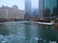 Ice chunks on a frozen Chicago River in January alongside snow covered riverwalk. Royalty Free Stock Photo