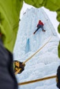 Ice climber belay with a rope and click up. hands close up