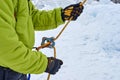 Ice climber belay with a rope and click up. hands close up. Providing safety