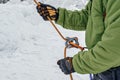 Ice climber belay with a rope and click up. hands close up. Providing safety