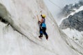 Ice climber with ice axes vertical climbing