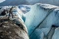 Ice climber looking into a huge crevasse on the Matanuska Glacier