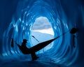 Ice climber resting in hammock inside a deep blue ice cave in the Matanuska Glacier of Alaska Royalty Free Stock Photo