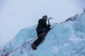 Ice climber scaling ice wall Royalty Free Stock Photo
