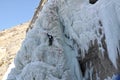 Ice climbing competition. Climbers climb an ice cliff Royalty Free Stock Photo