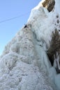 Ice climbing competition. Climbers climb an ice cliff Royalty Free Stock Photo